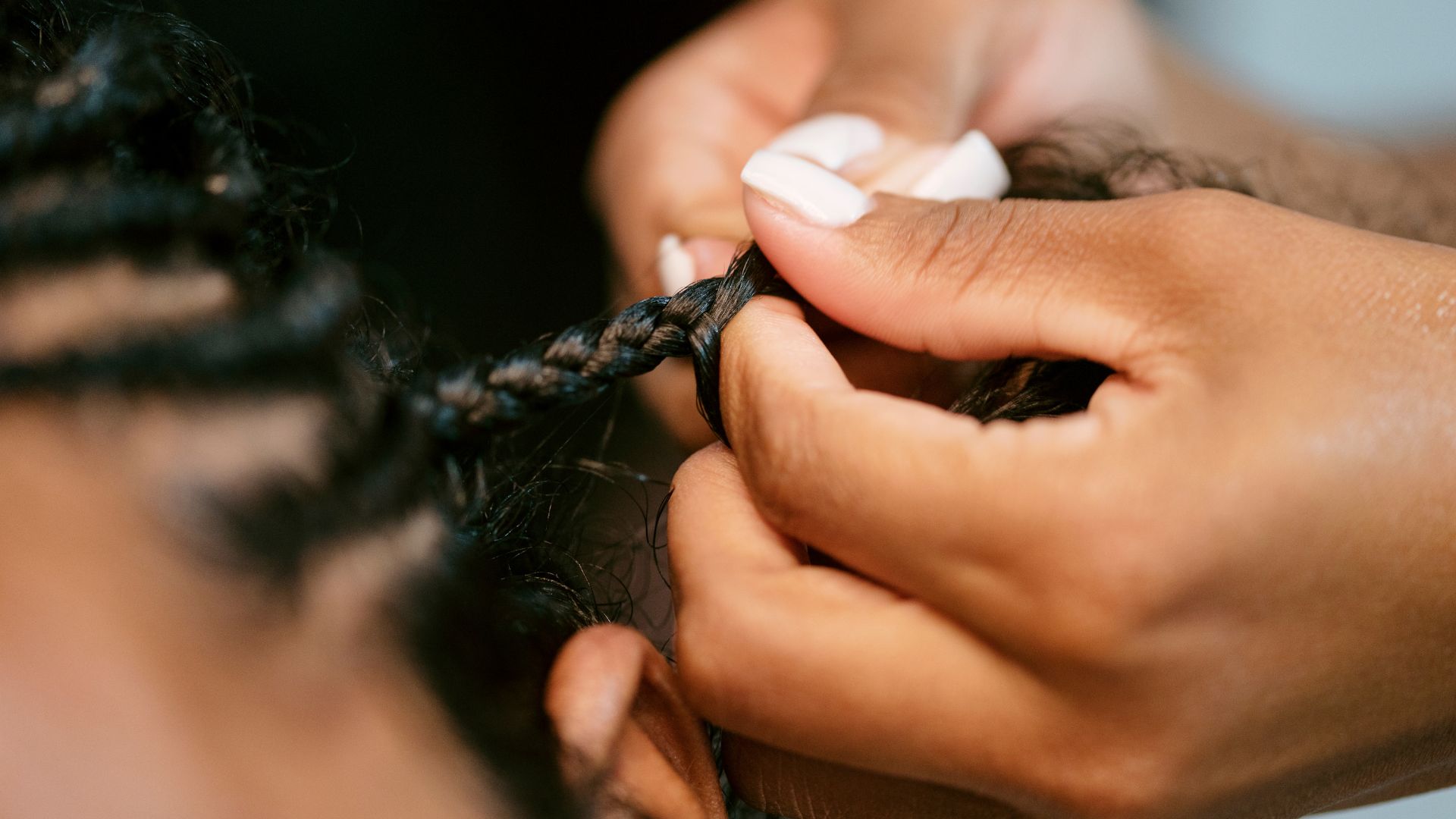 A close up of a person cutting another persons hair